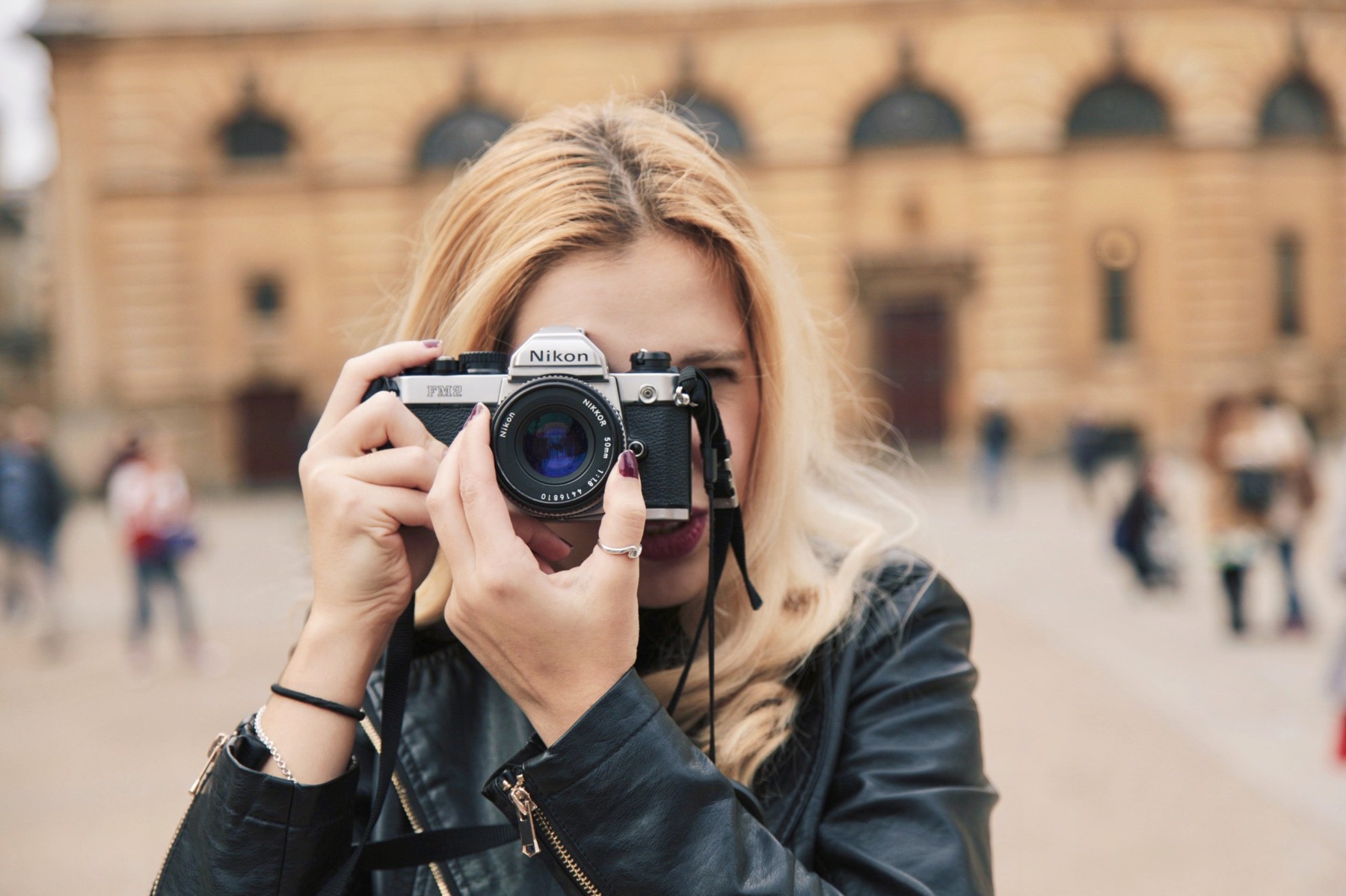 Mihaela holding a Nikon film camera, from her personal archive