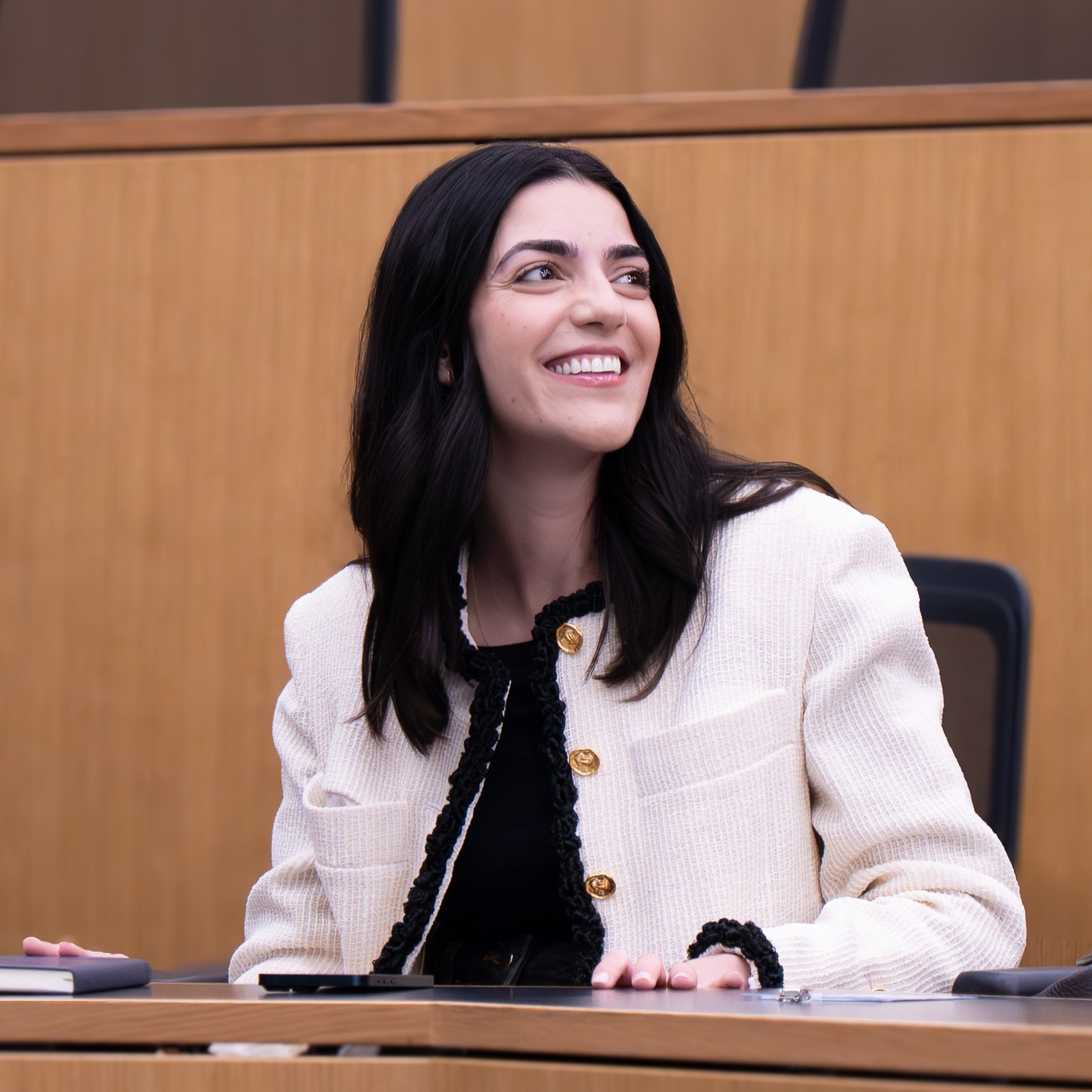 An Executive Education participant smiling and looking towards the right, photographed by Mihaela Motica