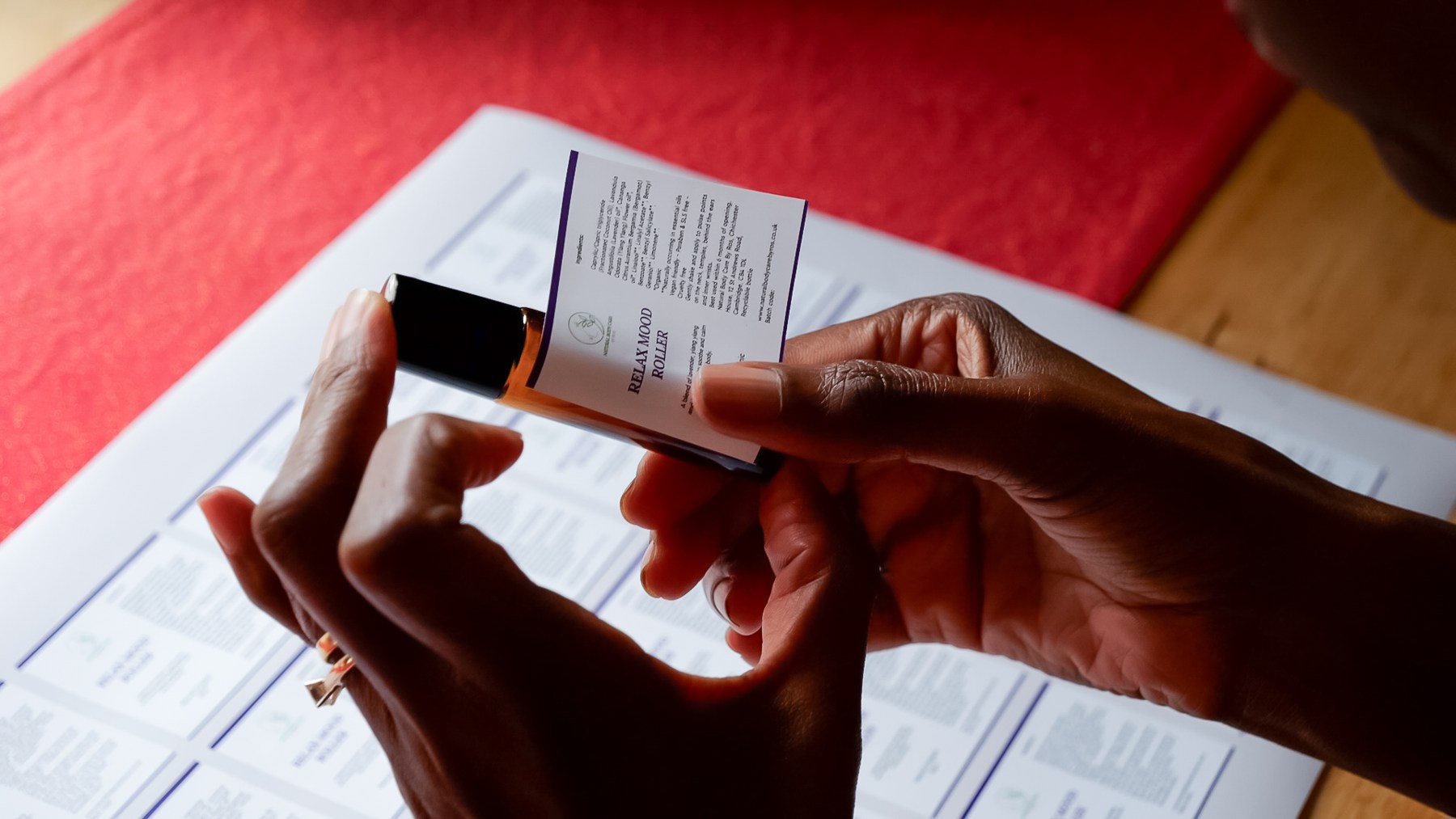 Hands applying a label to a jar